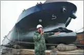  ?? RAO GUOJUN / FOR CHINA DAILY ?? A technician directs the hauling of a ship at a shipyard in Chongqing.