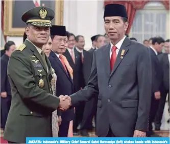  ??  ?? JAKARTA: Indonesia’s Military Chief General Gatot Nurmantyo (left) shakes hands with Indonesia’s President Joko Widodo after the swearing-in ceremony at the presidenti­al palace in this file photo.