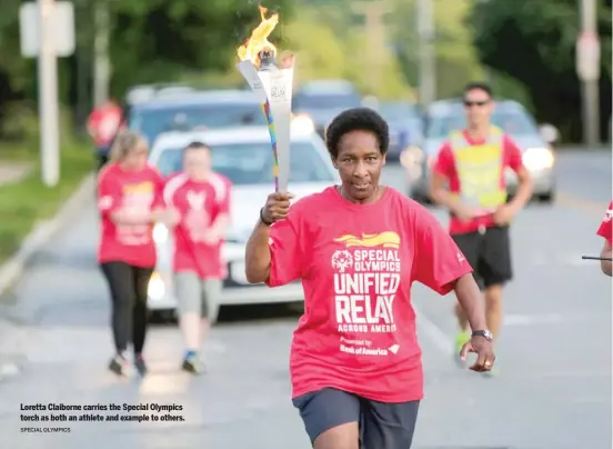  ?? SPECIAL OLYMPICS ?? Loretta Claiborne carries the Special Olympics torch as both an athlete and example to others.