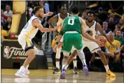  ?? RAY CHAVEZ — BAY AREA NEWS GROUP ?? The Boston Celtics' Jayson Tatum (0) dribbles against the Golden State Warriors' Stephen Curry (30), Andrew Wiggins (22) and Draymond Green (23) in the fourth quarter of Game 1of the NBA Finals at the Chase Center in San Francisco on Thursday.