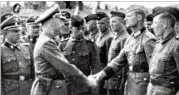  ?? PUBLIC PROSECUTOR’S OFFICE IN HAMBURG ?? This 1942 photo shows Heinrich Himmler (center left) shaking hands with new guard recruits at the Trawniki concentrat­ion camp in Nazi occupied Poland, where Jakiw Palij was a guard.