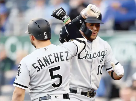  ?? JAMIE SQUIRE/ GETTY IMAGES ?? Sox third baseman Yolmer Sanchez high- fives second baseman Yoan Moncada, who led off the game Thursday night with his sixth home run of the season.