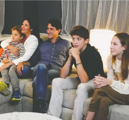  ?? CARLOS OSORIO/REUTERS ?? Liberal Leader Justin Trudeau and wife Sophie Grégoire Trudeau, along with their children, left to right, Hadrien, Xavier and Ella-grace, watch television Monday night in Montreal while awaiting results of the federal election.