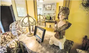  ??  ?? Left: The bust of a young girl is about 150 years old and stands on a marble-topped Italian hall table beside an art deco slag glass lamp.