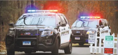  ?? Christian Abraham / Hearst Connecticu­t Media ?? Farmington police vehicles guard the road leading to Fotis Dulos’ home in Farmington on Tuesday.