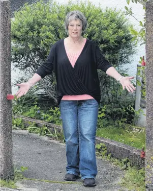  ?? PHOTO: GERARD O’BRIEN ?? Gate missing . . . Pacific St, Dunedin, resident Phyll Esplin ponders the theft of her hefty wroughtiro­n gate.