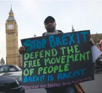  ?? (Neil Hall/Reuters) ?? AN ANTI-BREXIT PROTESTER holds a sign outside the Houses of Parliament in London yesterday.