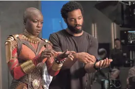  ??  ?? Danai Gurira, who plays Okoye, works with director Ryan Coogler.