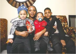  ?? STAFF PHOTO BY DOUG STRICKLAND ?? Patrice Martin and her sons Juan Cash, right, Sampson Martin, left, and Elijah Martin pose for a photo at Signal Centers on Tuesday. Martin is enrolled in the Baby University program, which helps parents establish effective early childhood developmen­t...