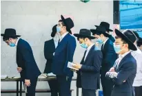  ?? (Yossi Aloni/Flash90) ?? ULTRA-ORTHODOX men pray. The subsidies amount to between NIS 900 and NIS 1,300 per child.