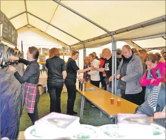  ?? 01_B29beer04 ?? The beer flows in the packed marquee.