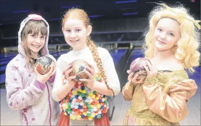  ?? MITCH MACDONALD/THE GUARDIAN ?? Members of the Charlottet­own Naiads, Adrienne Scales, left, Sara MacDonald and Ella Storey, show off their costumes during the Bowl for Kids Sake tournament on P.E.I. over the weekend.