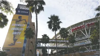  ?? THE ASSOCIATED PRESS ?? An image of baseball great Jackie Robinson, the man who broke baseball’s colour barrier, hangs near Petco Park in San Diego, where Wednesday’s game between the Padres and Mariners was cancelled. Players on both teams were protesting the weekend shooting of Jacob Blake, a Black man, by police in Wisconsin.