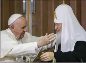  ?? GREGORIO BORGIA — THE ASSOCIATED PRESS ?? Pope Francis, left, reaches to embrace Russian Orthodox Patriarch Kirill after signing a joint declaratio­n at the Jose Marti Internatio­nal airport in Havana, Cuba.