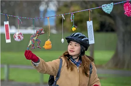  ?? MURRAY WILSON/STUFF ?? Rebecca Shoy checks out the woolly creations.