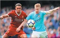  ?? PHIL NOBLE / REUTERS ?? Manchester City's Kevin De Bruyne (right) challenges Liverpool's Trent Alexander-Arnold during their English Premier League match at Etihad Stadium in Manchester on Saturday. City won 5-0.