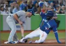  ?? THE CANADIAN PRESS/NATHAN DENETTE ?? Toronto Blue Jays left fielder Teoscar Hernandez (37) slides into third base for a triple as Kansas City Royals third baseman Mike Moustakas (8) is late on the tag during seventh inning AL baseball action in Toronto on Wednesday.