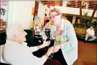  ?? Andrew Rush/post-gazette ?? Arlene Oehling sings for Eleanor Pelkey, a resident at the Palms at O’Neil, an assisted living facility in McKeesport.