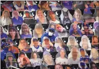  ?? John Minchillo / Associated Press ?? A Citifield worker sits amongst cardboard cutouts of spectators populating the stands in the fifth inning against the Miami Marlins in New York in August.