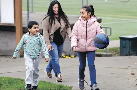  ??  ?? Lara Mae Chollette, a coach of youth soccer and basketball in Seattle, with her children Linda, 10, and Jaylen, 7. Chollette and her husband have been setting more boundaries around coaching responsibi­lities and she also wonders whether parents should...