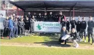  ??  ?? Stanley players welcome Andrew Turner, on to the pitch at the Wham Stadium