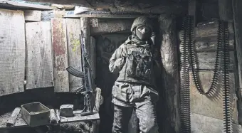  ?? ?? A Ukrainian soldier stands in a shelter on a position at the line of separation near Zolote, Ukraine, Feb. 19, 2022.