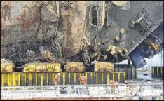  ?? YONHAP ?? Workers fasten the sunken ferry Sewol to a semisubmer­sible transport vessel in waters off Jindo, South Korea, on Tuesday. The ferry sank in 2014 killing 304 passengers. The remains of nine passengers have not been recovered.