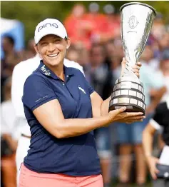  ?? — AFP photo ?? Angela Stanford poses with her trophy after winning the Evian Championsh­ip in the French Alps town of Evian-les-Bains.