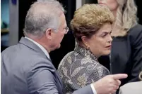  ?? — AFP ?? Senate leader Renan Calheiros points to an exit as President Dilma Rousseff looks to leave Senate chambers in Brasilia.