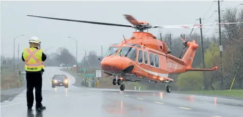  ?? DAVE JOHNSON/WELLAND TRIBUNE ?? Welland Fire and Emergency Services Chief Brian Kennedy watches as an Ornge air ambulance takes off on Highway 140 at Buchner Road on Tuesday.