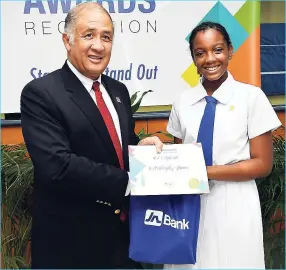  ??  ?? Ashleigh James, of Immaculate Conception High School receives her JN Foundation 2018 Scholarshi­p certificat­e from Parris Lyew-Ayee, chairman of the JN Foundation.