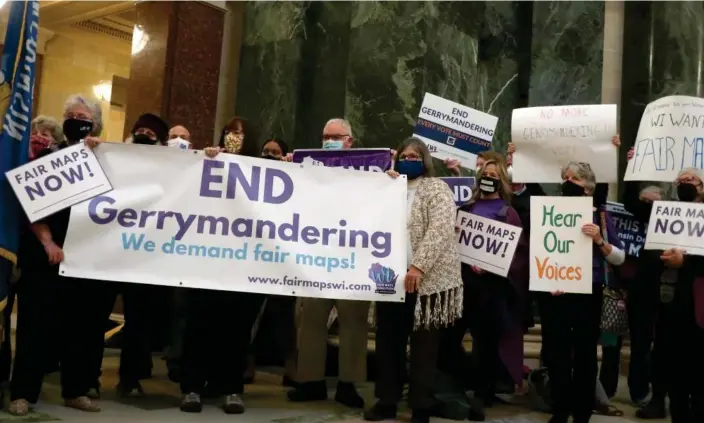  ?? Photograph: Scott Bauer/AP ?? More than 100 opponents of the Republican redistrict­ing plans vow to fight the maps at a rally ahead of a joint legislativ­e committee hearing at the Wisconsin state capitol in Madison, Wisconsin, Oct. 28, 2021.