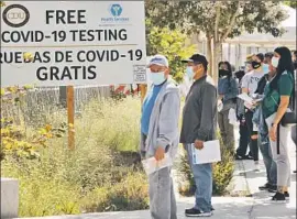  ?? Al Seib Los Angeles Times ?? PEOPLE wait to get tested at the Charles R. Drew University of Medicine and Science in Willowbroo­k. The rate of infection varies by race, county officials said.