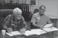  ?? The Sentinel-Record/Richard Rasmussen ?? GETTING READY: Garland County election commission­ers Harold “Butch” Davis, left, and Ralph Edds make preparatio­ns for the May 22 elections. They were appointed to the commission by their respective county party committees in January 2017.
