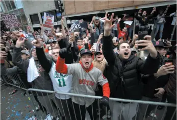  ?? AP PHOTO ?? Boston Red Sox fans cheer during a parade to celebrate the team’s World Series championsh­ip on Wednesday in Boston.