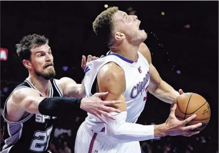  ?? Wally Skalij Los Angeles Times ?? GETTING A STEP on Spurs center Tiago Splitter, Blake Griffin draws a foul while driving to the basket. The Clippers power forward had a strong all-around game, finishing with 26 points, 12 rebounds, six assists, three blocked shots and three steals.