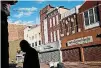  ?? [AP PHOTO] ?? A man walks past vacant storefront­s at the Old Town Mall in Baltimore. Job growth was supposed to be a cure-all to stop the wealth gap from worsening, but new research suggests that impoverish­ed Americans are getting left out.