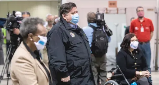  ?? TYLER LARIVIERE/ SUN- TIMES FILE PHOTO ?? Mayor Lori Lightfoot ( from left), Gov. J. B. Pritzker and U. S. Sen. Tammy Duckworth, D- Ill., tour the $ 65.9 million emergency coronaviru­s hospital at McCormick Place on April 17 — the day Pritzker announced the first five patients had been transferre­d there. Only 33 more would follow.