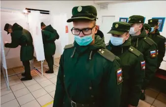  ?? Dmitri Lovetsky / Associated Press ?? Russian soldiers line up to vote at a polling station outside St. Petersburg. A voting app designed by opposition activists disappeare­d from the Google and Apple app stores Friday.