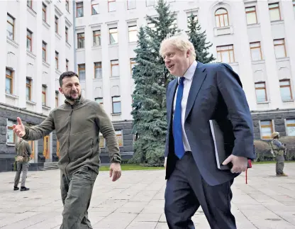  ?? ?? Ukraine’s leader, Volodymyr Zelensky, welcomes Boris Johnson to Kyiv, where they discussed ‘financial and military aid’ and Britain’s ‘long term support’