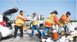  ?? ANNIE RICE/CORPUS CHRISTI CALLER-TIMES VIA AP ?? Corpus Christi city workers load free sandbags for residents ahead of Tropical Storm Beta on Saturday in Corpus Christi, Texas. The storm is expected to produce 4 to 6 inches of rain Sunday night through Monday morning in South Texas.