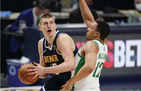  ?? Ap pHoToS ?? DIGGING IN: Celtics forward Grant Williams, right, defends Nuggets center and MVP candidate Nikola Jokic.