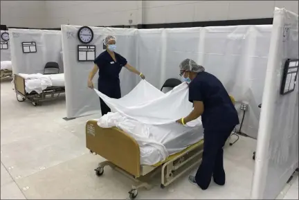  ?? CALIFORNIA OFFICE OF EMERGENCY SERVICES VIA THE ASSOCIATED PRESS ?? Hospital beds are set up Dec. 9 in the practice facility at Sleep Train Arena in Sacramento, Calif., that is ready to receive patients as needed.