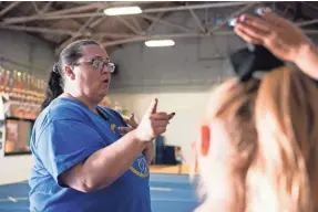  ?? PHOTOS BY SANDY HOOPER/USA TODAY ?? Mishelle Robinson, owner of Empire All Stars, talks to cheerleade­rs during practice on Aug. 19 in Ravenna, Ohio.