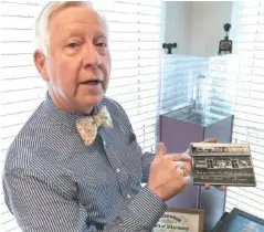  ?? STAFF PHOTO BY MARK KENNEDY ?? Steve McDonough shows off a photo of his family’s former business, Incline Drugs.