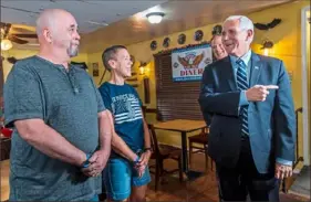  ?? Steph Chambers/Post-Gazette ?? David’s Diner owners David and Lisa Speer greet Sen. Pat Toomey and Vice President Mike Pence before lunch Friday at the Springdale diner.