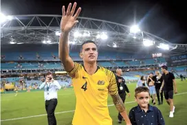  ??  ?? Retiring Australian forward Tim Cahill waves to supporters after playing in the internatio­nal friendly against Lebanon at the Sydney Olympic Stadium yesterday. Australia won 3-0. — AFP