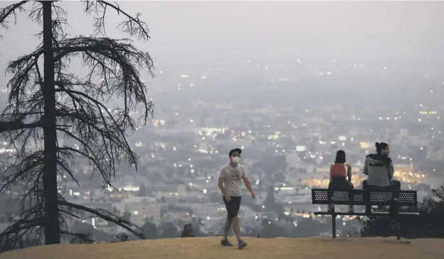  ?? PICTURE: MARIO TAMA/GETTY ?? 0 Los Angeles is smothered by a dark orange cloud as wildfires burn out of control in many parts of the western USA