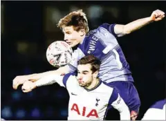  ?? AFP ?? Wanderers midfielder David Wheeler (top) vies with Spurs midfielder Harry Winks in both teams’ FA Cup fourth round match on Monday.