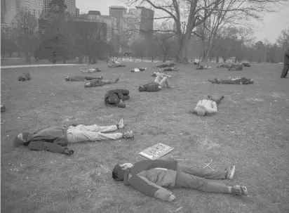  ?? KASSI JACKSON/HARTFORD COURANT ?? Protesters participat­ed Wednesday in a “die-in,” lying down at the edge of Hartford’s Bushnell Park to draw attention to their opposition to a proposed natural gas plant in Killingly.